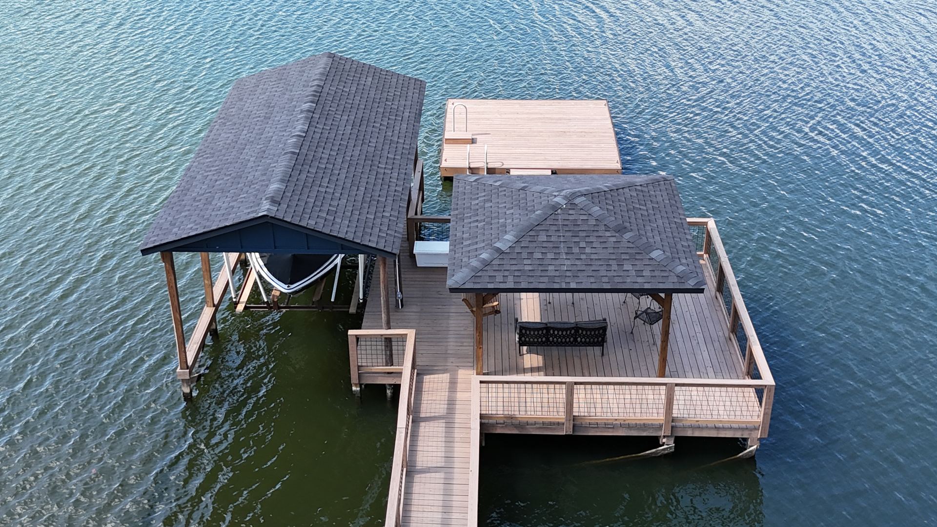 Overhead view of the covered dock, boat, and seating