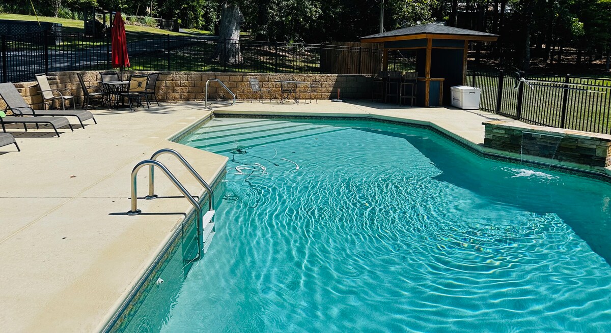 Saltwater pool with waterfall wall and cabana